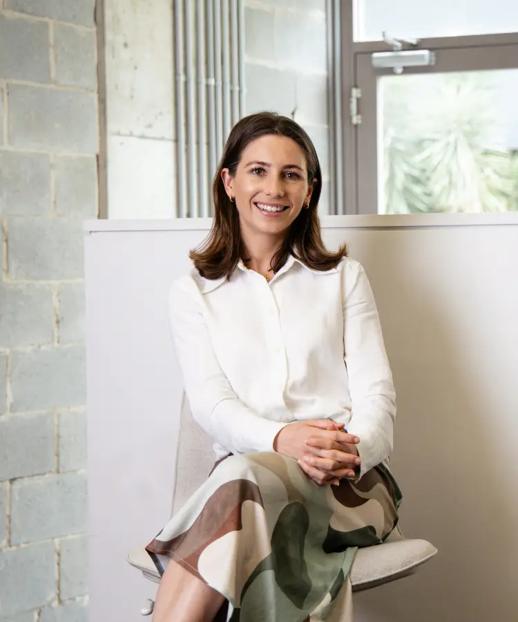 Lucy Smith, Dietitian, sits comfortably on a chair with a welcoming smile