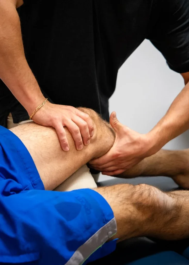 Close-up of a physiotherapist performing manual therapy on a patient's knee